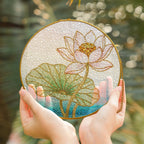 Pink lotus blossom stained glass suncatcher held in hand