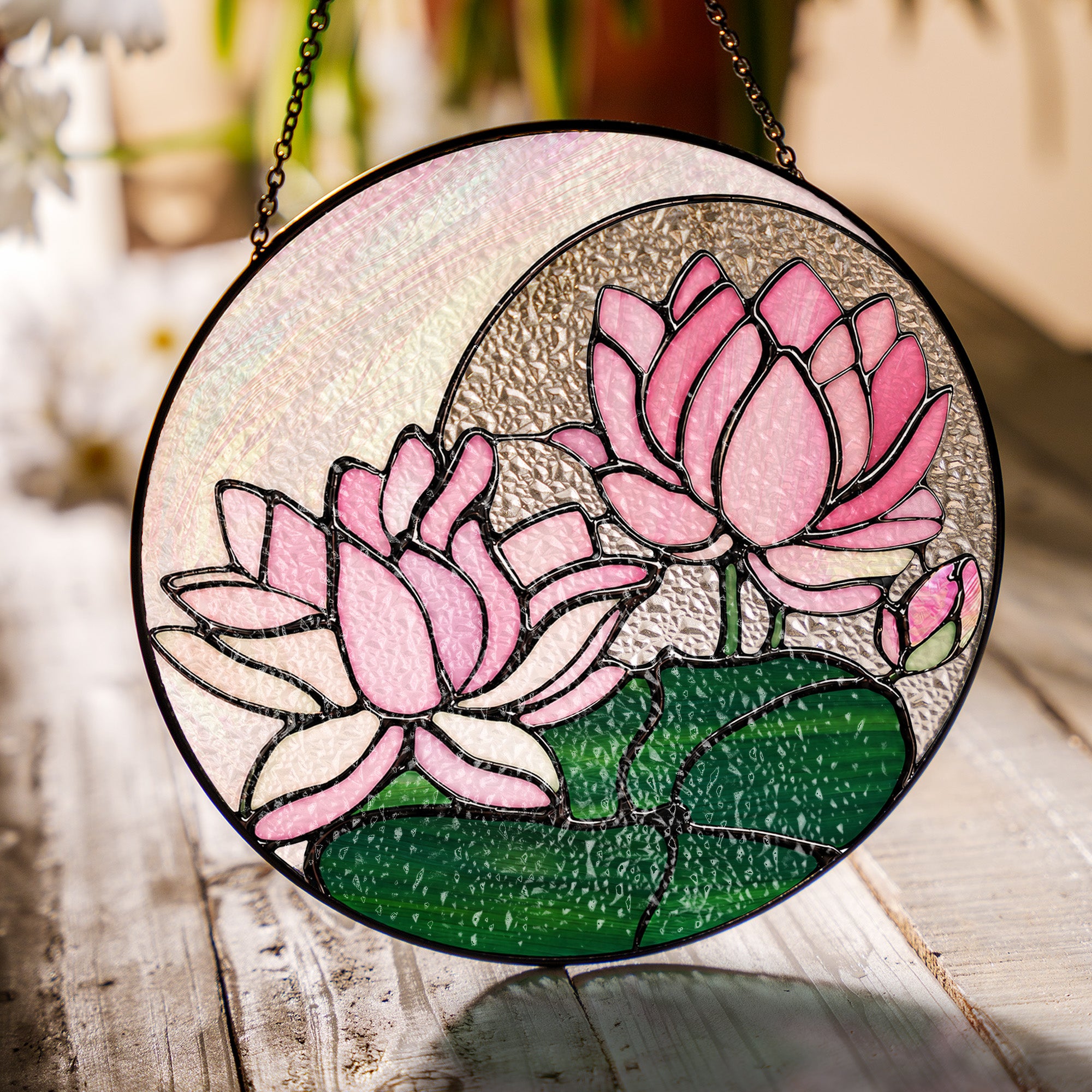 Pink lotus stained glass suncatcher in a bright window with soft daylight