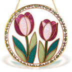 Pink tulip stained glass suncatcher hanging in a window