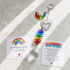 Personalized dog memorial Rainbow Bridge crystal suncatcher displayed with sympathy card and Rainbow Bridge poem card on a marble surface