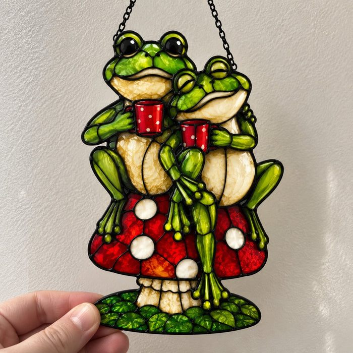 Frog Couple on Mushroom suncatcher held against a sunlit wall