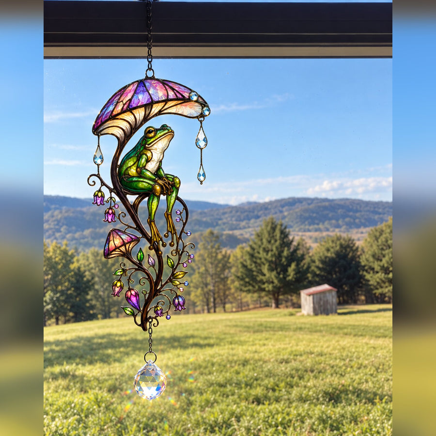 Frog & Mushroom Umbrella suncatcher in a window over rolling hills