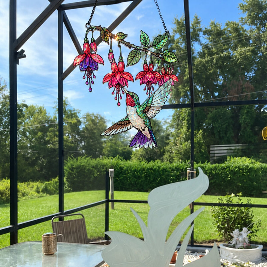 Fuchsia Hummingbird suncatcher hanging in a screened patio