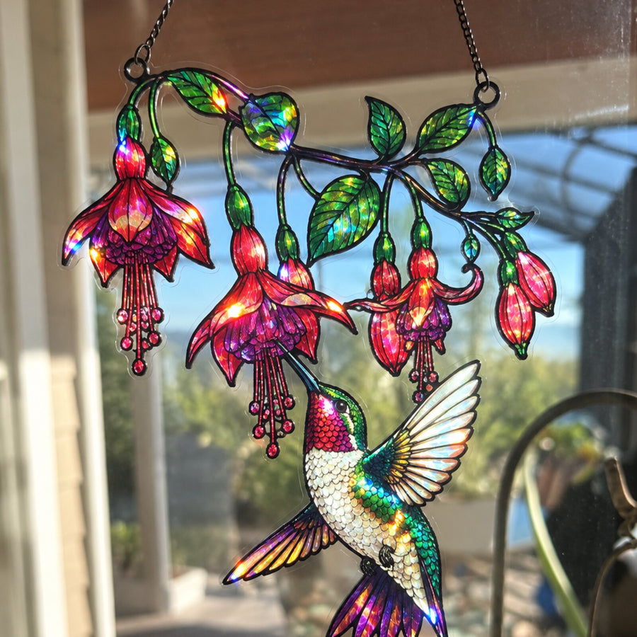 Fuchsia Hummingbird suncatcher glowing in a sunroom window