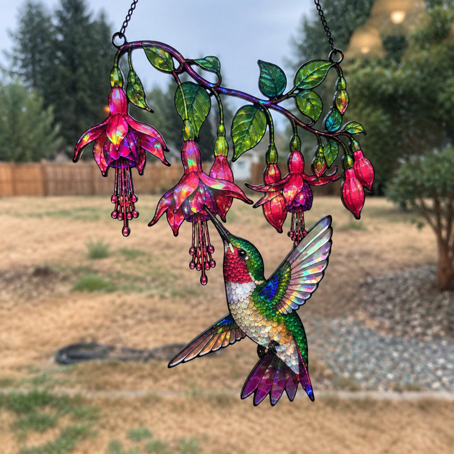 Fuchsia Hummingbird suncatcher in a backyard window