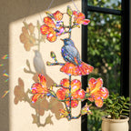 Robin and orange trumpet flower holographic acrylic suncatcher reflecting rainbow light across a room