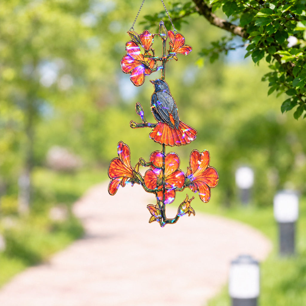 Robin and orange trumpet flower holographic suncatcher catching sunlight and casting rainbow reflections in a window