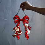Santa & Snowman Hanging from Red Bow Holographic Acrylic Suncatcher