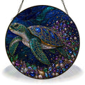Sea turtle ocean stained glass suncatcher, jeweled turtle on a deep blue background