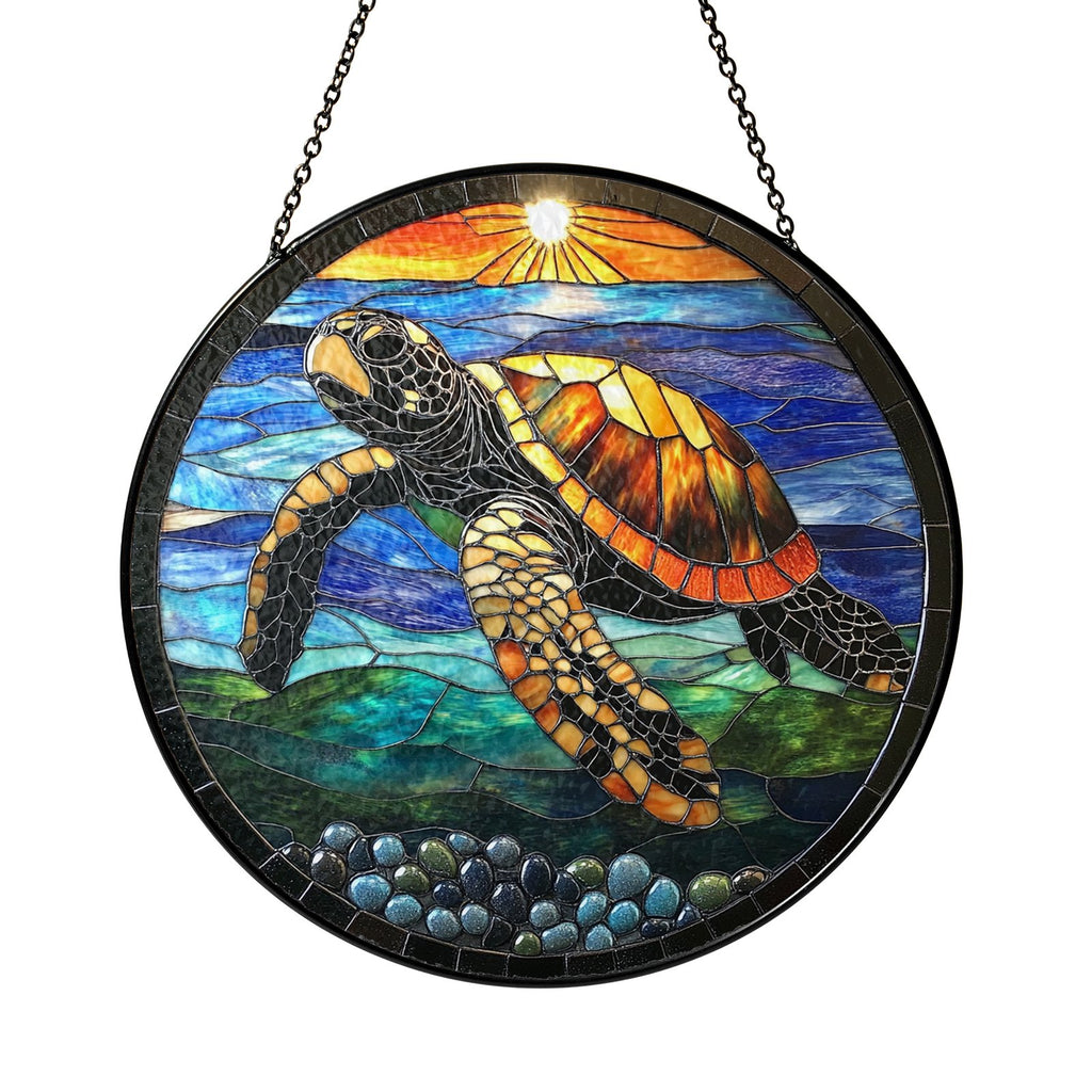Sea turtle sunset suncatcher hanging by a window with plants