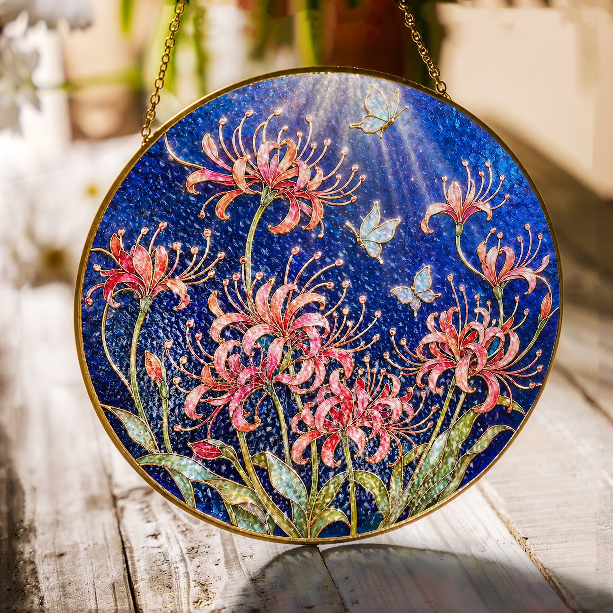 Spider lily and butterfly stained glass suncatcher with gold frame on a white background