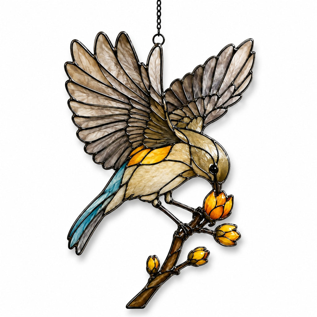 Stained glass style suncatcher with a songbird with open wings on a branch of golden buds, hanging in a sunlit window with rainbow light
