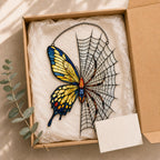 Yellow Butterfly on Spider Web holographic acrylic suncatcher hanging in a sunlit window
