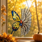 Yellow Butterfly on Spider Web suncatcher catching afternoon light in a home window