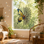 Yellow Butterfly on Spider Web window suncatcher seen against a sunlit garden