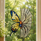 Yellow Butterfly on Spider Web holographic suncatcher hanging in a living room window