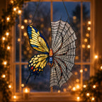Yellow Butterfly on Spider Web suncatcher displayed in a home window