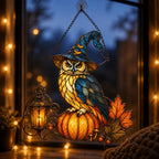 Witch Hat Owl on Pumpkin suncatcher on its metal hanging chain in a bright window