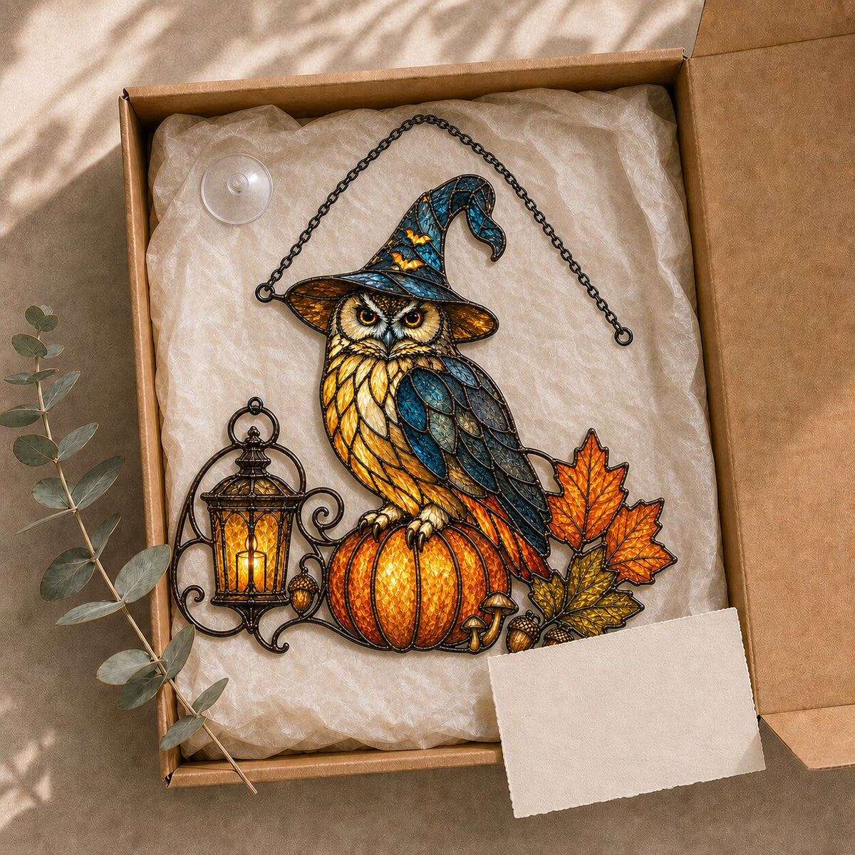 Witch Hat Owl on Pumpkin holographic suncatcher hanging in a living room window