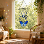 Blue Spider on Web suncatcher on its metal hanging chain in a bright window