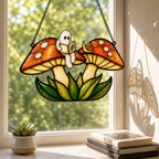 Two Ghosts on Red Mushrooms window suncatcher seen against a sunlit garden