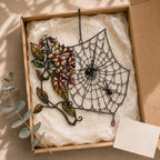 Autumn Spider Web with Flowers holographic acrylic suncatcher hanging in a sunlit window