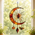 Crescent Moon Spider Web with Bats acrylic suncatcher hanging in a window with seasonal decor