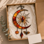 Crescent Moon Spider Web with Bats window suncatcher seen against a sunlit garden