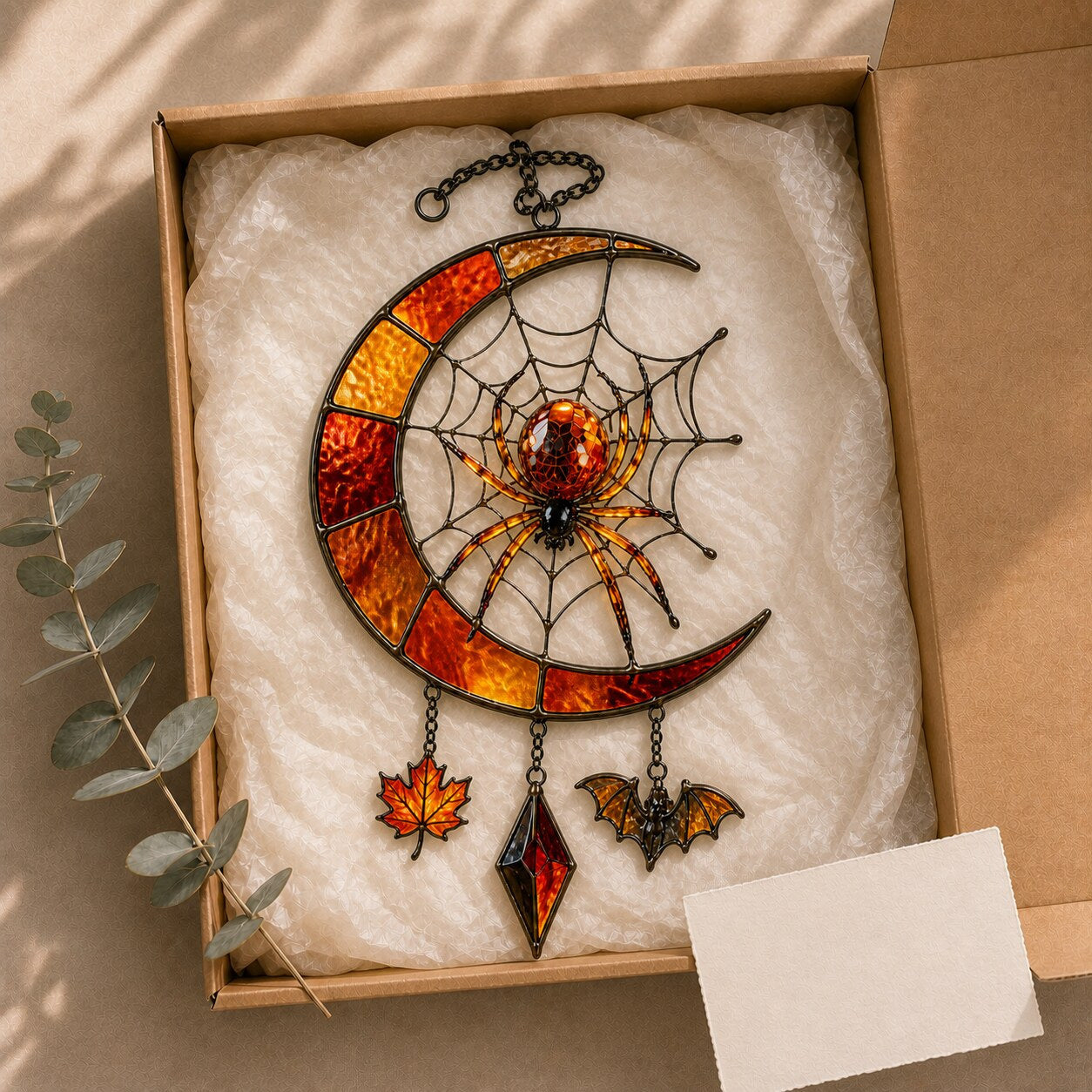 Crescent Moon Spider Web with Bats window suncatcher seen against a sunlit garden
