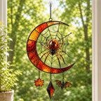 Crescent Moon Spider Web with Bats suncatcher beside a window with seasonal decor