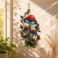 Red Mushroom Cluster with Vines suncatcher displayed in a home window