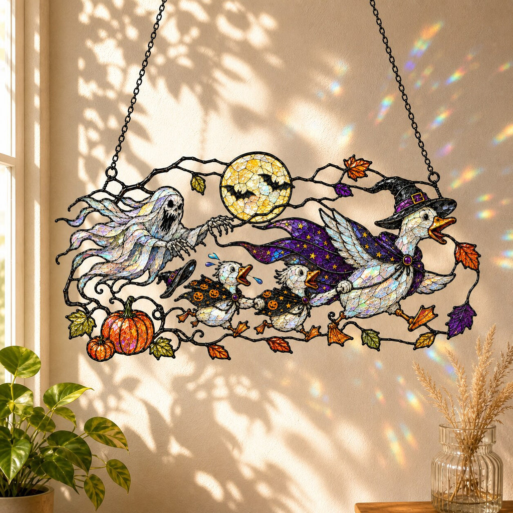 Ghosts and Ravens under the Harvest Moon holographic acrylic suncatcher hanging in a sunlit window