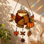 Cozy Autumn Coffee Mug with Pumpkins holographic suncatcher hanging in a living room window