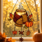 Cozy Autumn Coffee Mug with Pumpkins acrylic suncatcher in a warm, softly lit interior