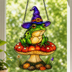 Witch Hat Frog on Red Mushroom acrylic suncatcher hanging in a window with seasonal decor
