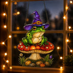 Witch Hat Frog on Red Mushroom holographic suncatcher hanging in a living room window