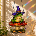 Witch Hat Frog on Red Mushroom suncatcher beside a window with seasonal decor