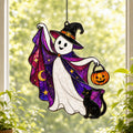 Trick-or-Treat Ghost with Pumpkin Bucket suncatcher catching afternoon light in a home window