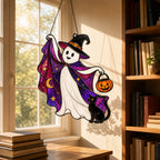 Trick-or-Treat Ghost with Pumpkin Bucket suncatcher beside a window with seasonal decor