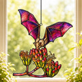 Pink Bat over Autumn Blooms suncatcher catching afternoon light in a home window