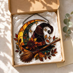 Witch Hat and Broom on Crescent Moon acrylic suncatcher in a warm, softly lit interior