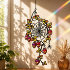 Spider Web with Autumn Berries suncatcher on its metal hanging chain in a bright window