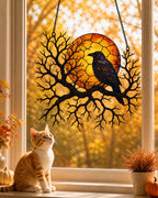 Raven on Branch with Harvest Moon acrylic suncatcher hanging in a window with seasonal decor