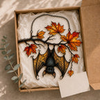 Sleeping Bat under Maple Branch acrylic suncatcher in a warm, softly lit interior