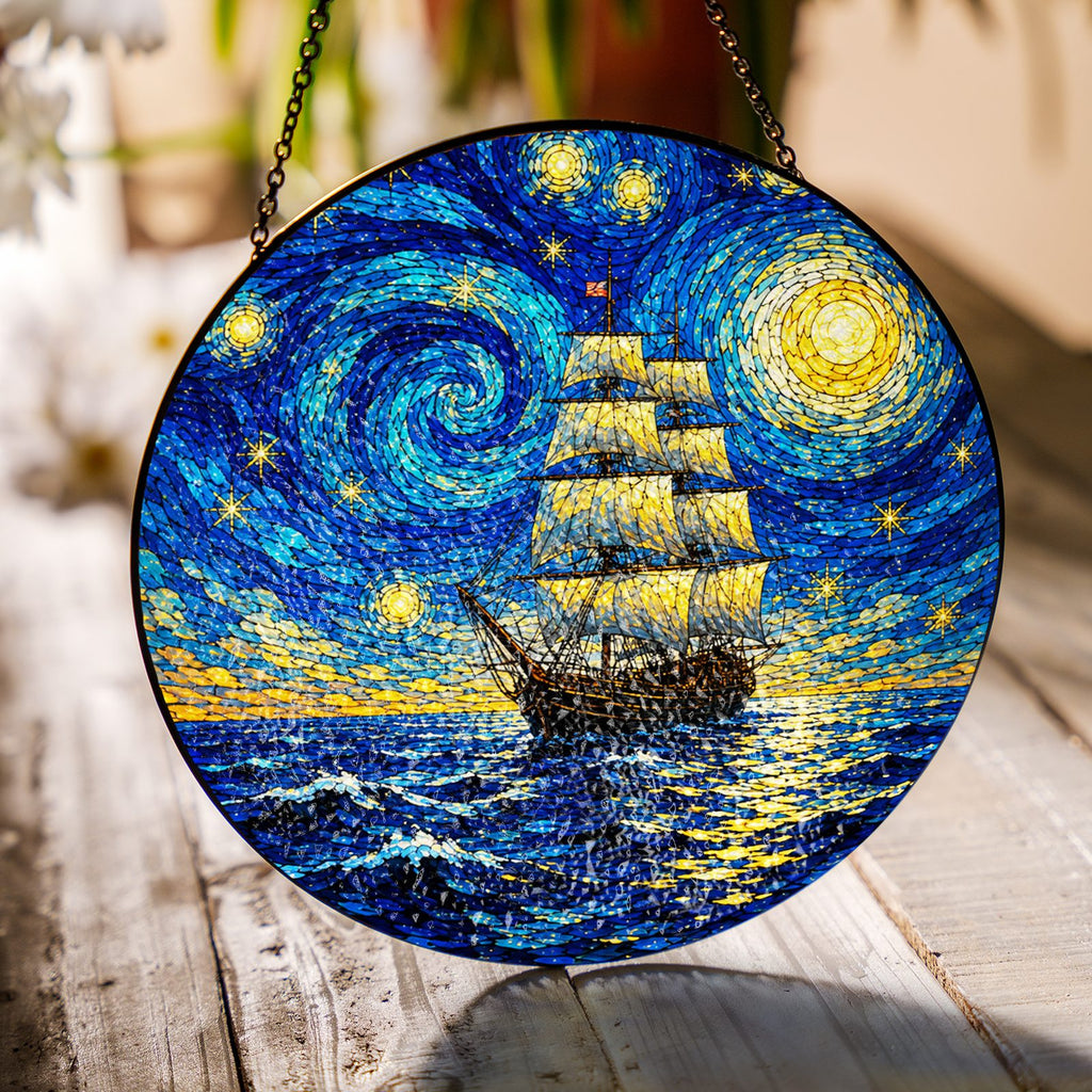 Starry Night tall ship suncatcher on a wooden table in sunlight