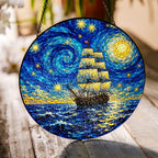 Starry Night tall ship suncatcher on a wooden table in sunlight