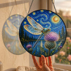 Hand holding the dragonfly suncatcher at a window