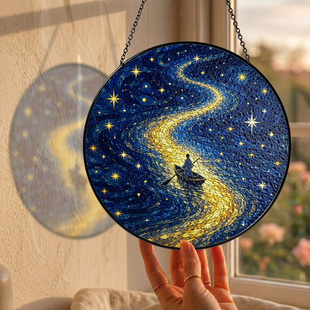 Hand holding the rowboat suncatcher at a window