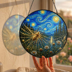 Hand holding the spider web suncatcher at a window