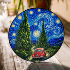Red car cypress road suncatcher on a wooden table in sunlight